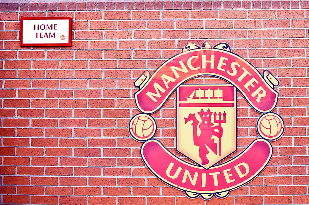 Manchester United logo on brick wall